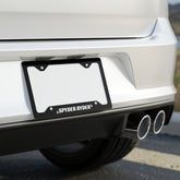 Car license plate with 'Spyder Ryder' branding on a blurred background